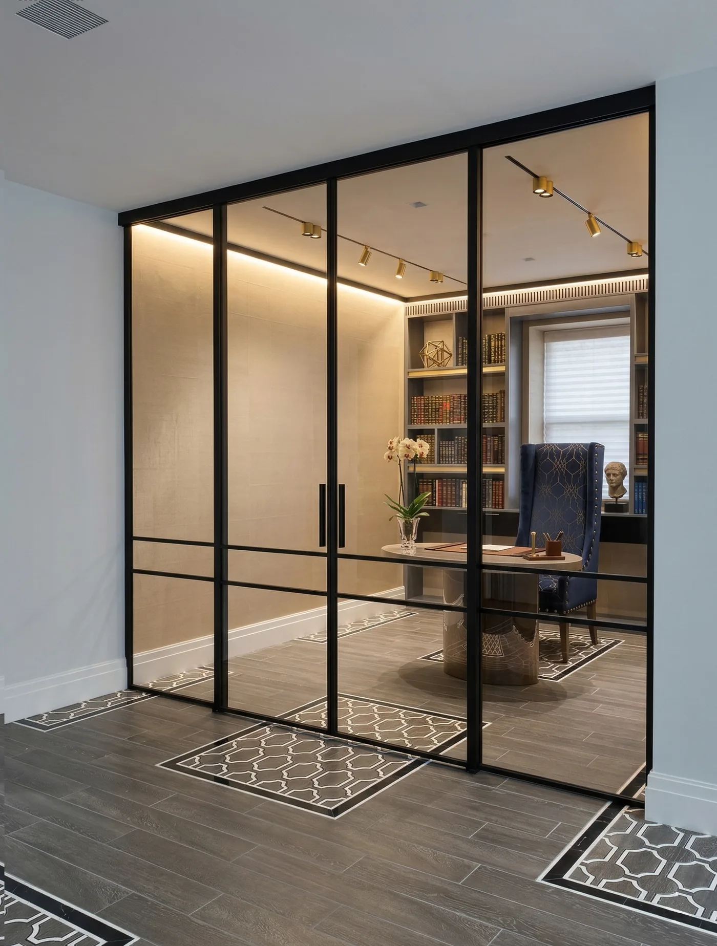 Bronze tinted sliding glass doors enclosing a home library
