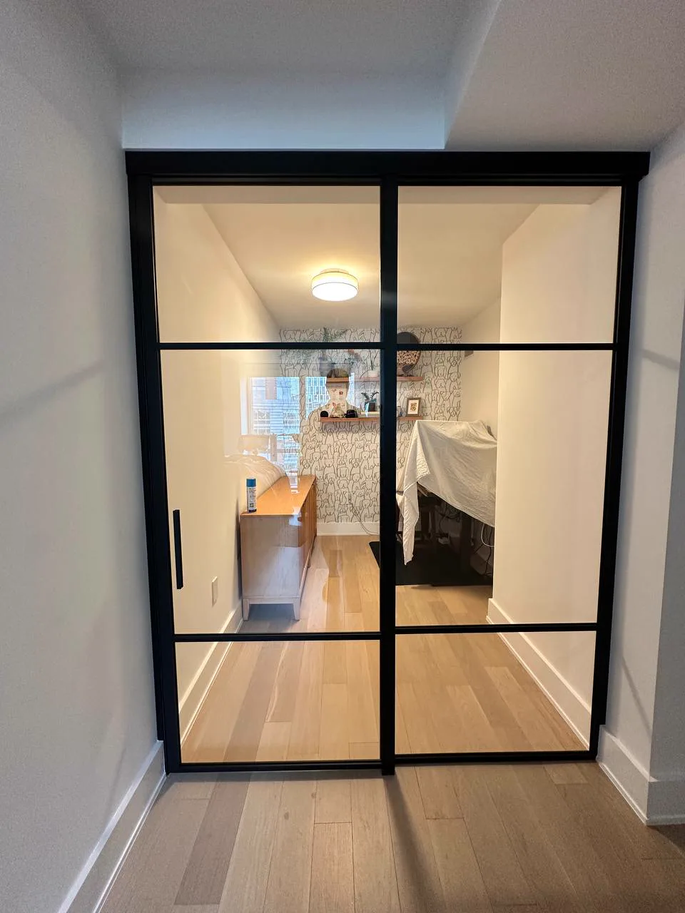 Single sliding glass door closed on a wall mounted track